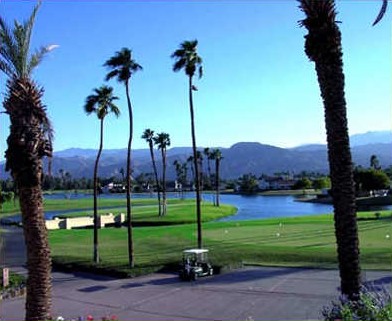 View of golf course lake with golf cart